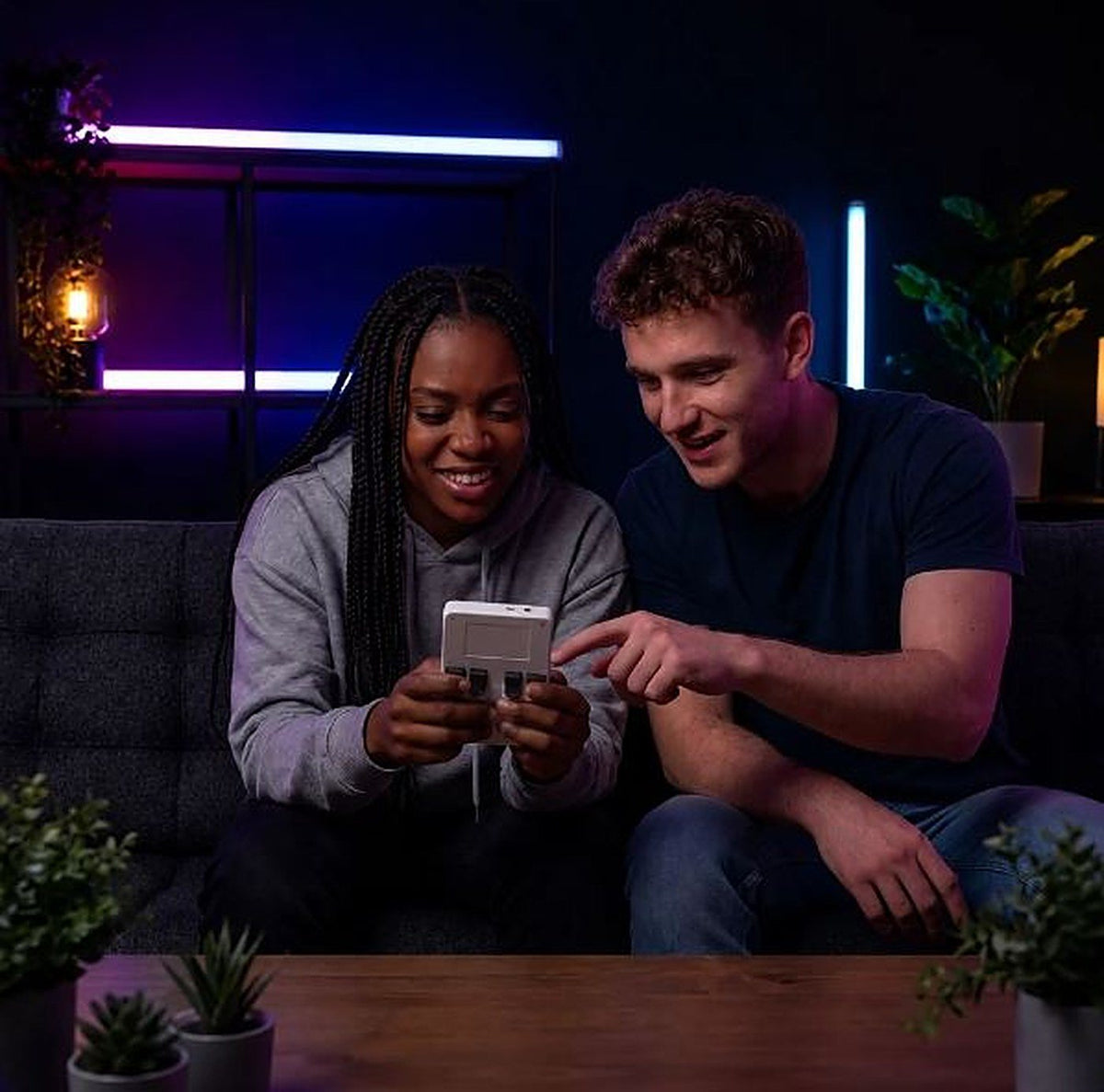 Two friends playing Replay Pocket on the couch
